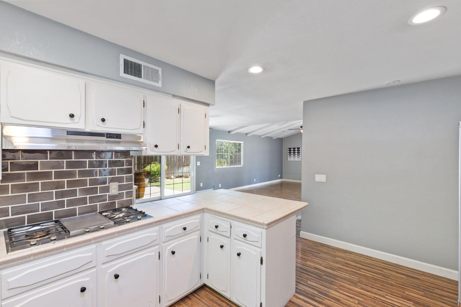 2012 Beverly Avenue Clovis, CA 93611 - Photo 16 of 42 a kitchen with granite countertop white cabinets and white appliances