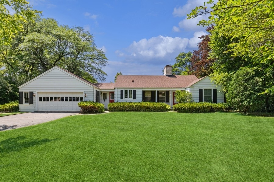 180 Wagner Road Northfield, IL 60093 - Photo 1 of 22 a front view of a house with a garden