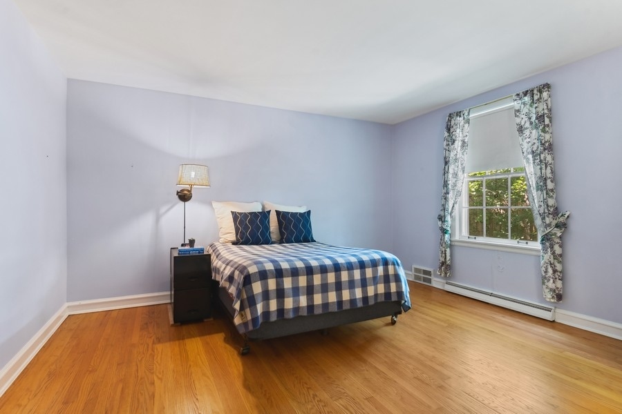 180 Wagner Road Northfield, IL 60093 - Photo 17 of 22 a bedroom with a bed and a window