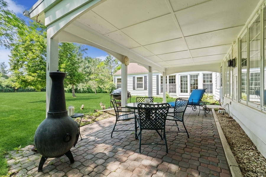 180 Wagner Road Northfield, IL 60093 - Photo 5 of 22 a view of a patio with a table chairs and a yard
