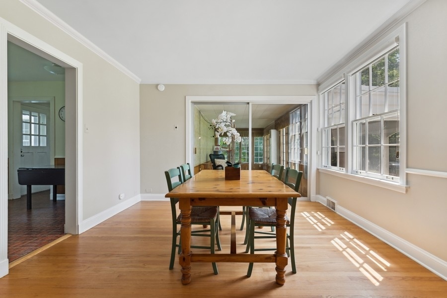 180 Wagner Road Northfield, IL 60093 - Photo 9 of 22 a dining room with furniture window and wooden floor