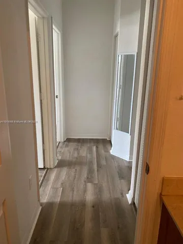 an entryway of a house with wooden floor