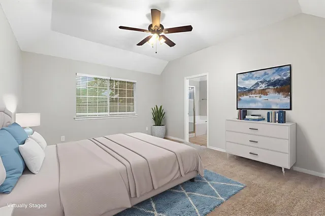 a bedroom with a bed and a painting on the wall