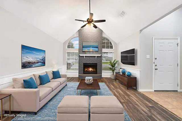 a living room with furniture and a fireplace