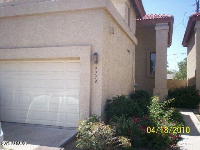 a couple of potted plants in front of door