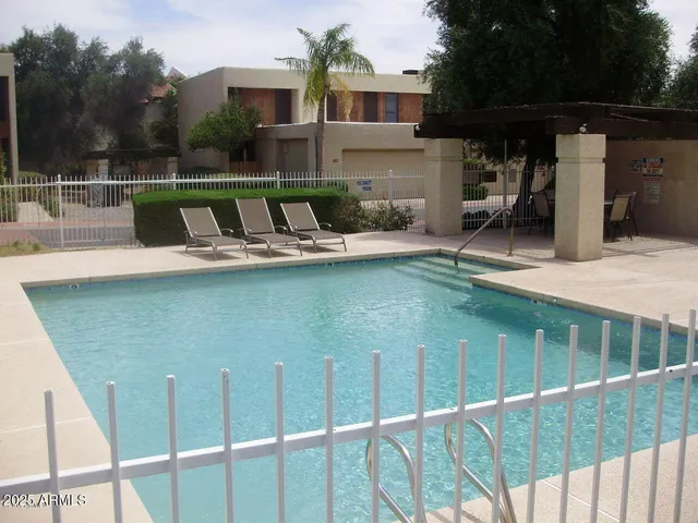 a view of a swimming pool with furniture