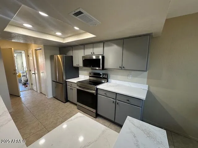 a kitchen with stainless steel appliances a refrigerator stove and microwave