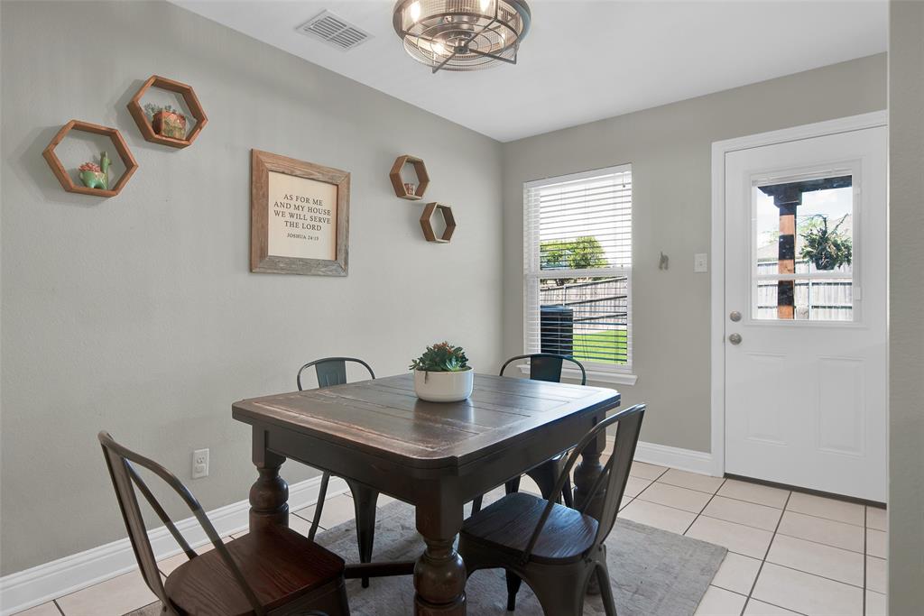 514 Brighton Ct Road Wylie, TX 75098 - Photo 11 of 25 a view of a dining room with a table and chairs