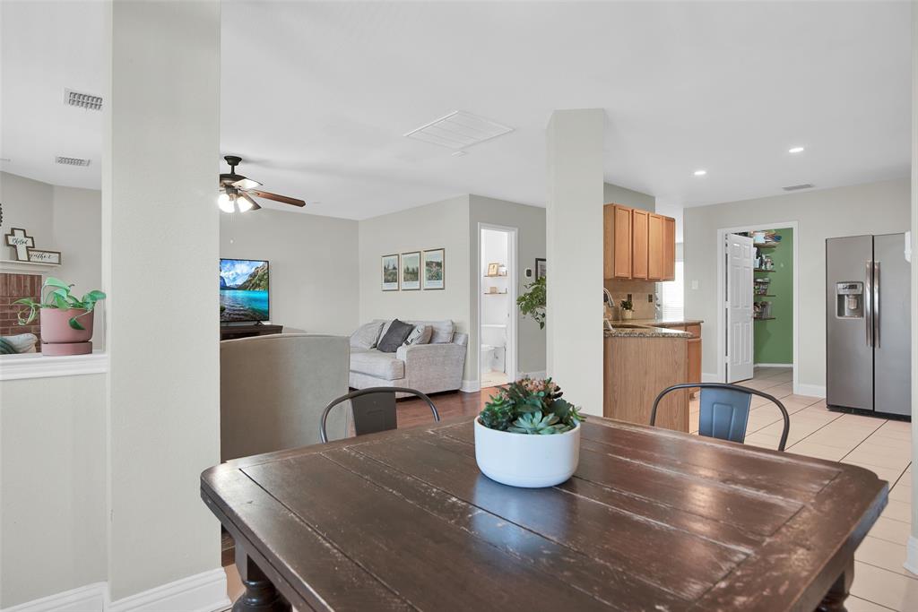 514 Brighton Ct Road Wylie, TX 75098 - Photo 12 of 25 a dining room with stainless steel appliances a dining table and chairs