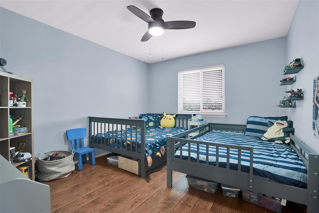 514 Brighton Ct Road Wylie, TX 75098 - Photo 17 of 25 a bedroom with a bed and a window