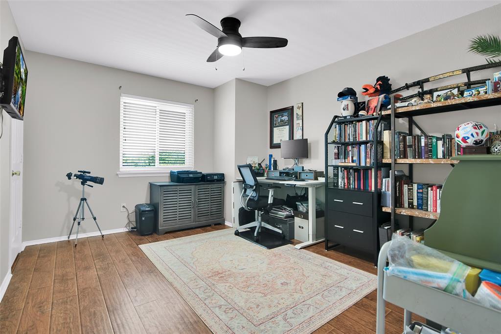 514 Brighton Ct Road Wylie, TX 75098 - Photo 18 of 25 a bed room with a bed and a book shelf