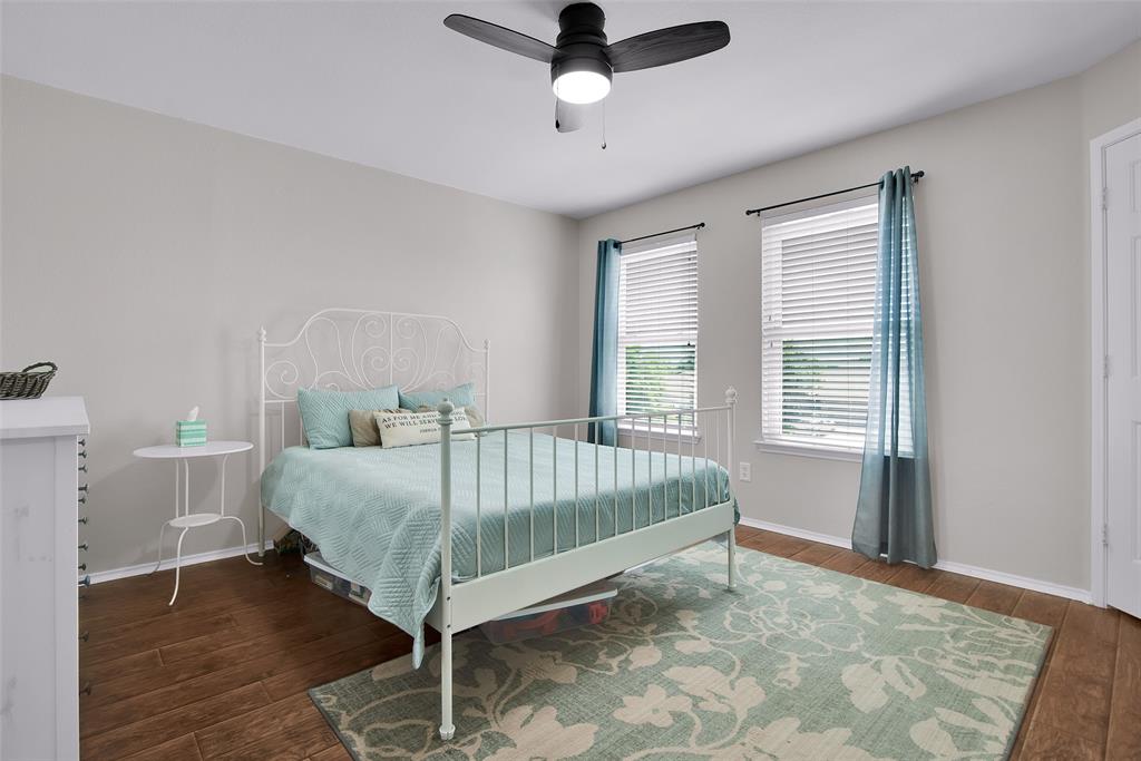 514 Brighton Ct Road Wylie, TX 75098 - Photo 19 of 25 a bed sitting in a bedroom next to a window