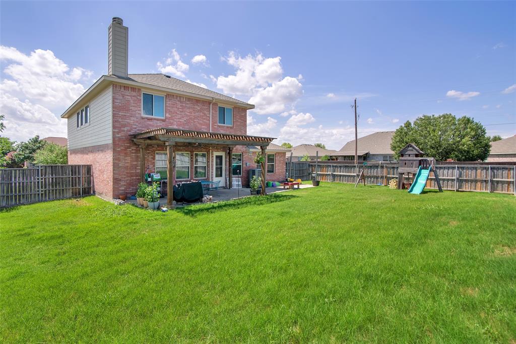 514 Brighton Ct Road Wylie, TX 75098 - Photo 23 of 25 a view of a house with a backyard