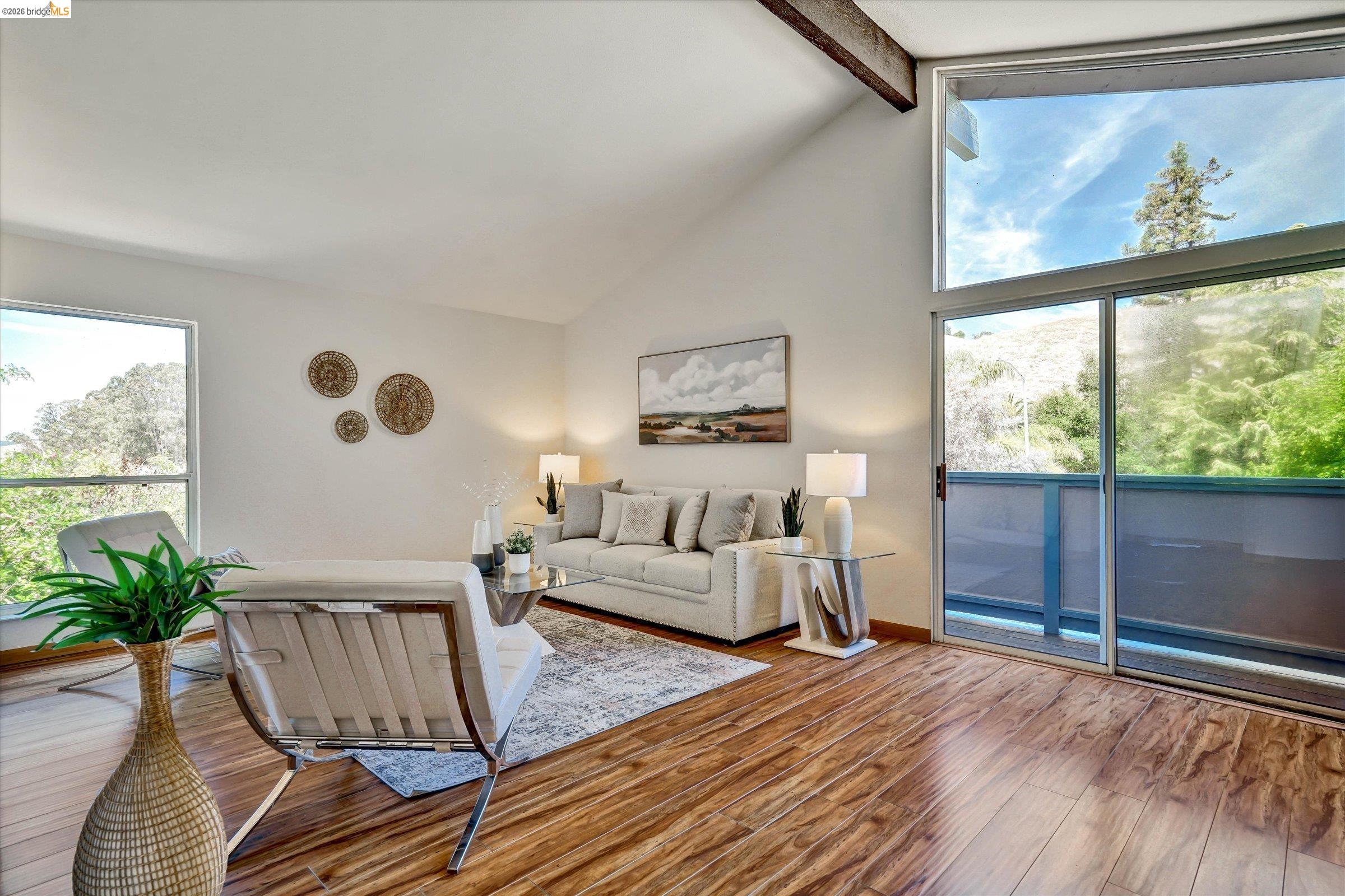 2826 Wright Avenue Pinole, CA 94564 - Photo 34 of 70 Vaulted ceilings with exposed wood beams, expansive sliding glass doors, and a large picture window create an airy atmosphere