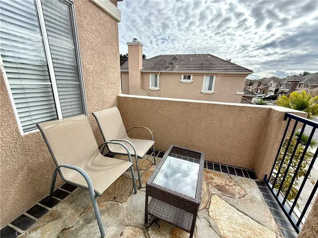 a backyard of a house with table and chairs