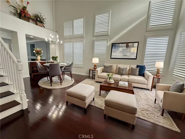 a living room with furniture wooden floor and a large window