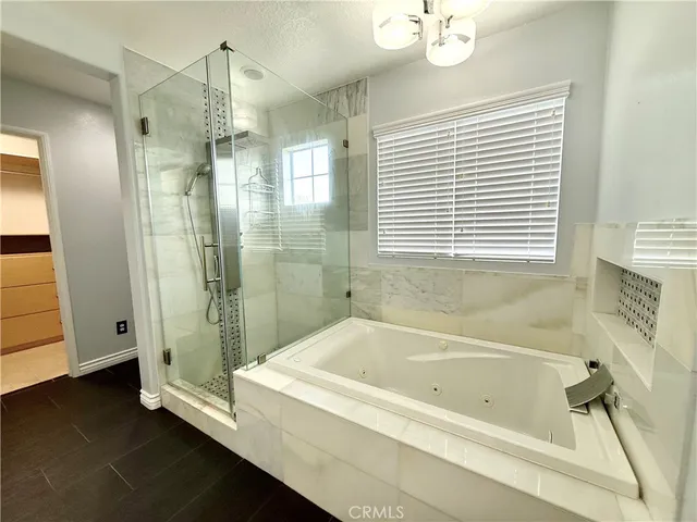 a bathroom with a bathtub and a shower