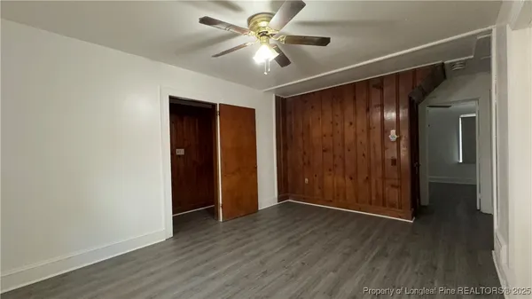 a view of an empty room with wooden floor