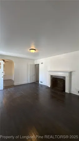 a view of empty room with a fireplace