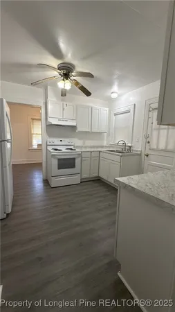a kitchen with stainless steel appliances granite countertop a sink and cabinets