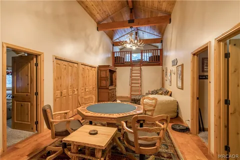 a dining room with furniture a chandelier and wooden floor