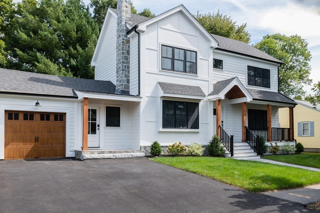 a front view of a house with a garden and yard