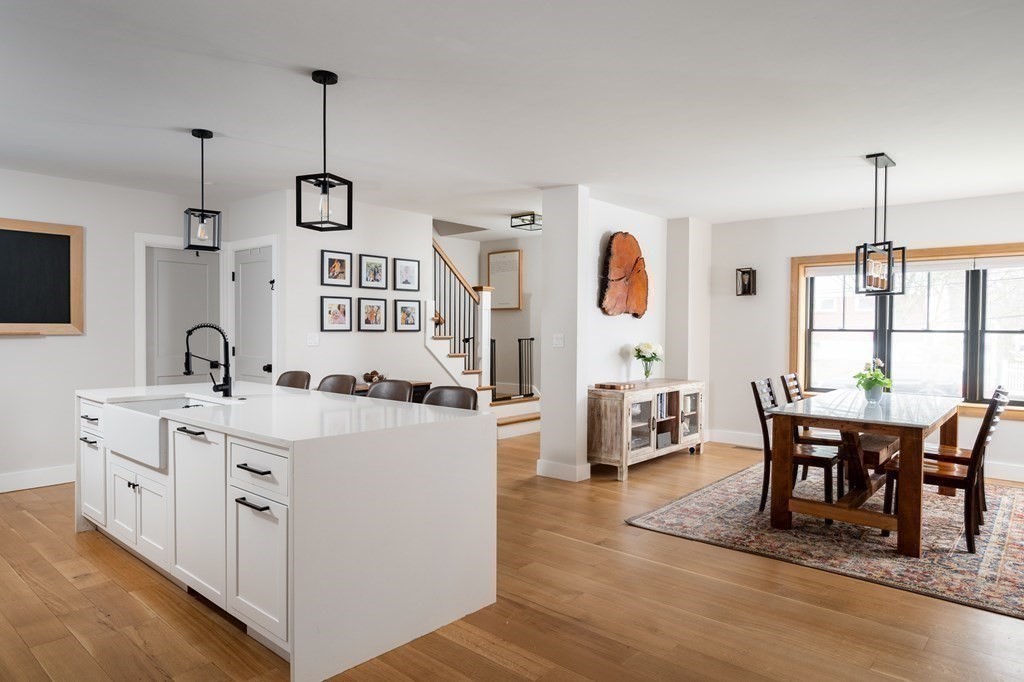 100 Gerald Road Milton, MA 02186 - Photo 12 of 42 a large kitchen with white cabinets and wooden floor