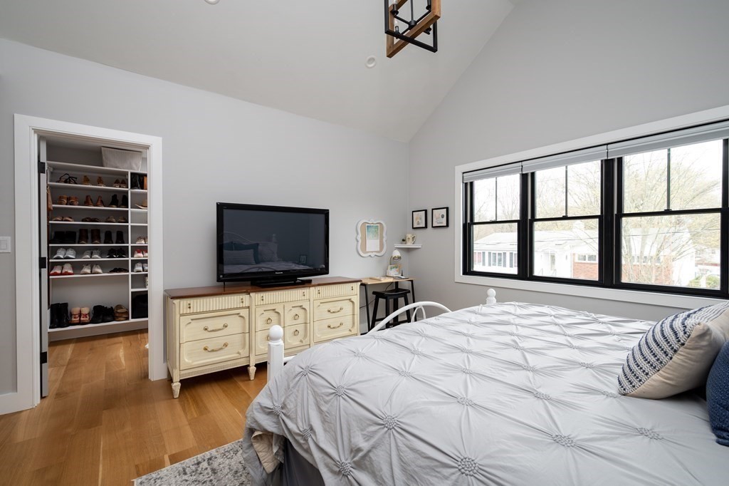 100 Gerald Road Milton, MA 02186 - Photo 28 of 42 a bedroom with a bed and a flat tv screen on dresser