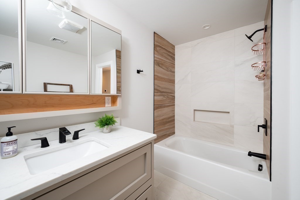 100 Gerald Road Milton, MA 02186 - Photo 33 of 42 a bathroom with a tub sink and mirror