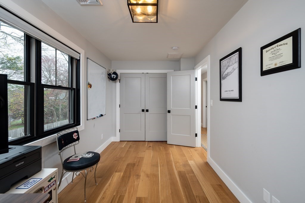 100 Gerald Road Milton, MA 02186 - Photo 34 of 42 a view of empty room with wooden floor and fan