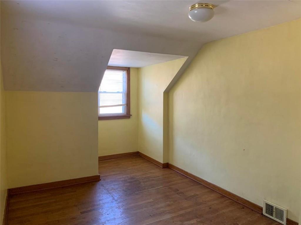 1616 Mercer Grove City Road Mercer, PA 16137 - Photo 17 of 23 an empty room with wooden floor and windows