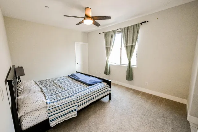a white bath tub sitting in a bathroom next to a window