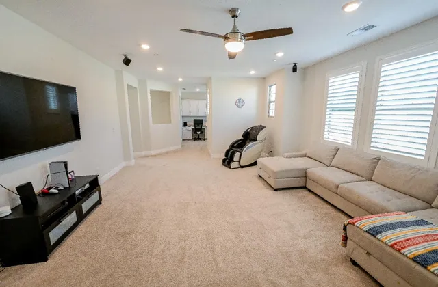 a spacious bathroom with a tub sink and mirror