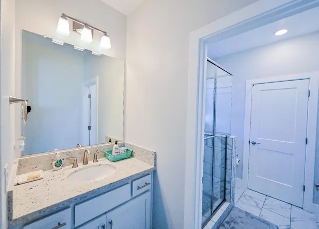 a living room with furniture a fireplace and a chandelier