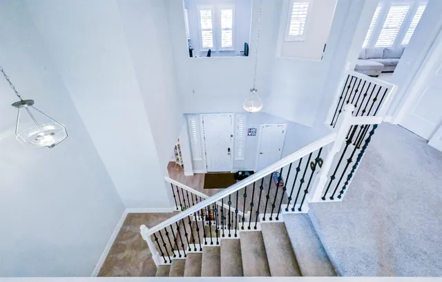 a kitchen with stainless steel appliances granite countertop a table chairs sink and cabinets