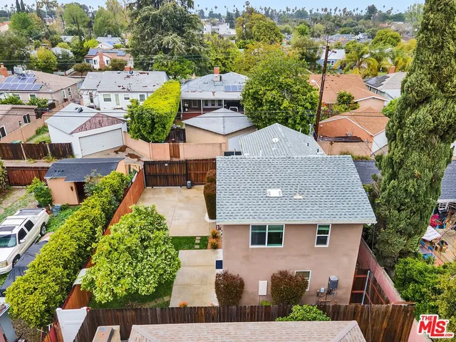 an aerial view of multiple houses with yard