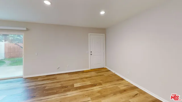 a view of a room with wooden floor