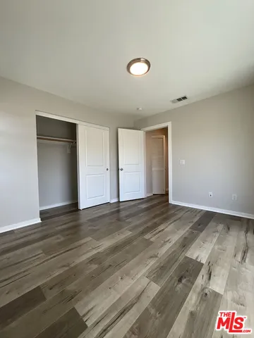 a view of an empty room and wooden floor
