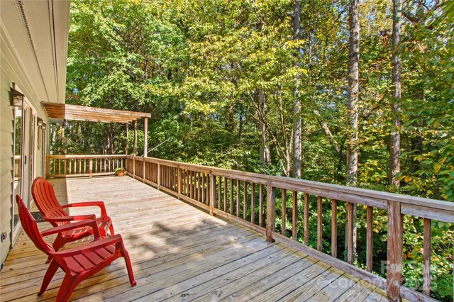 a view of balcony with wooden floor and outdoor seating