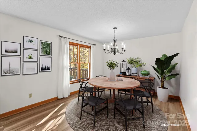 a view of a dining room with furniture and chandelier