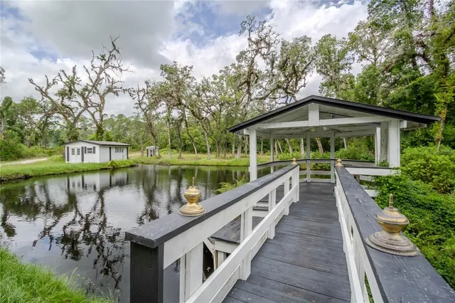 a view of a wooden deck and lake