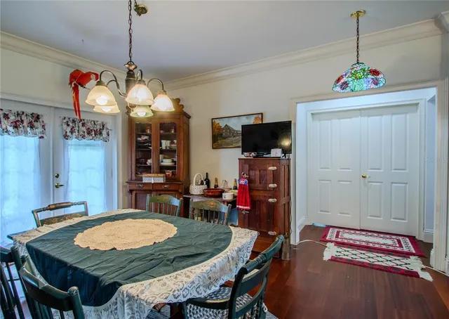 a view of a dining room with furniture and chandelier