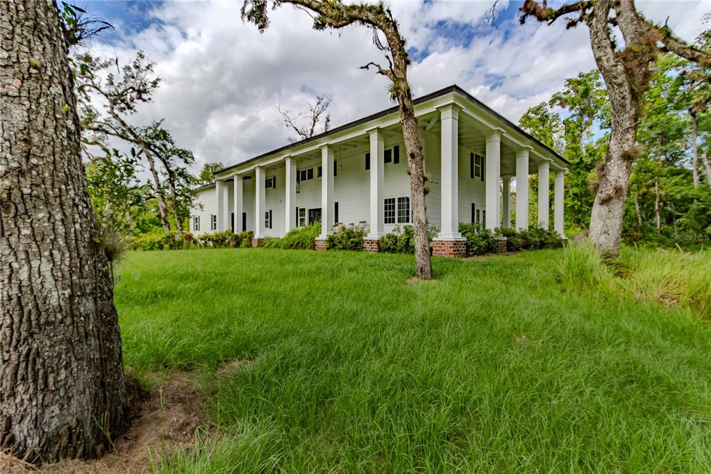500 South Fort Christmas Road Christmas, FL 32709 - Photo 8 of 25 a view of a house with big yard and large trees
