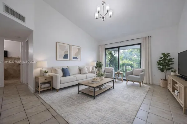 a living room with furniture and a chandelier