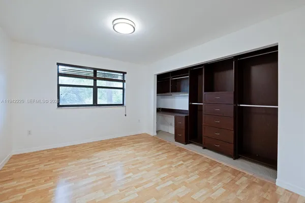 a bedroom with a bed and a television