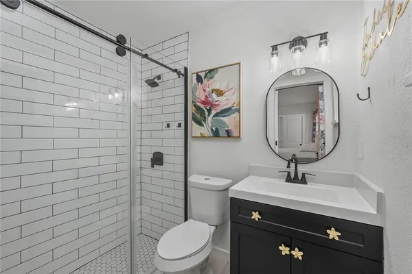 a bathroom with a toilet a sink and mirror