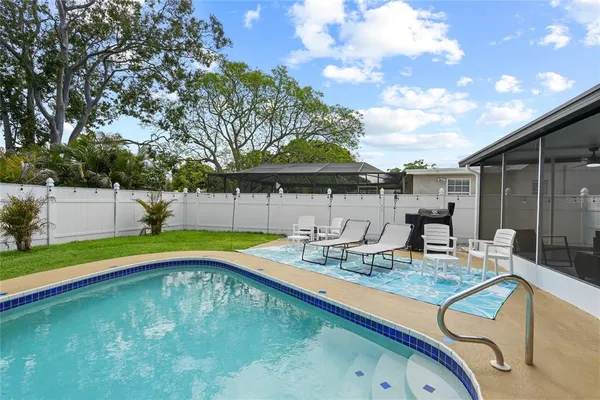 a swimming pool with some trees in the background