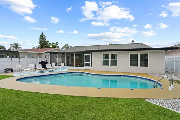 a front view of house with yard and swimming pool