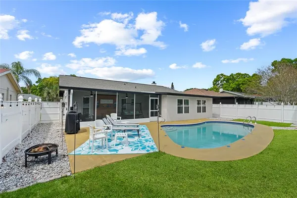 a view of a house with swimming pool and sitting area
