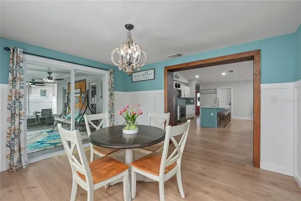 a view of a dining room with furniture and a chandelier